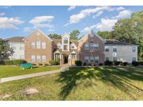 Brick apartment building with green space at 4390 Daphne Ln. # H, Murrells Inlet, SC 29576