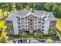Exterior view of multi-story building and parking at 4870 Luster Leaf Circle # 401, Myrtle Beach, SC 29577