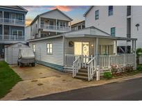 Front of house with small yard and golf cart at 6001-1092 S Kings Hwy., Myrtle Beach, SC 29575