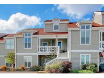 Two-story townhome with gray siding and red roof at 4396 Baldwin Ave. # 12, Little River, SC 29566