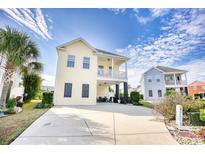 Two-story home with a wrap-around porch and attractive landscaping at 911 Ocean Pines Ct., North Myrtle Beach, SC 29582
