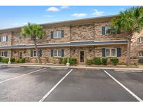 Brick building with parking lot and palm trees at 215 Double Eagle Dr. # G-2, Myrtle Beach, SC 29575