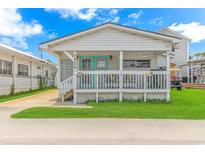 Quaint beach cottage with a welcoming front porch at 6001-1424 S Kings Hwy., Myrtle Beach, SC 29575