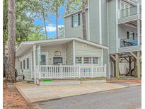 Small cottage with a deck and white railing at 6001-1359 S Kings Hwy., Myrtle Beach, SC 29575