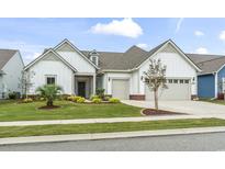 Charming two-story home with a two-car garage and well-manicured lawn at 7129 Spoleto Dr., Myrtle Beach, SC 29572