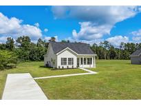 Newly constructed single story home with green lawn and driveway at 1234 St. John Rd., Galivants Ferry, SC 29544