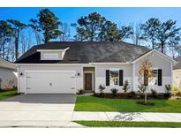 One-story house with gray siding, white trim, and a two-car garage at 623 Blackthorne Circle Nw, Calabash, NC 28467