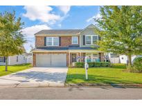 Brick two-story house with a two-car garage and landscaped lawn at 609 Glen Haven Dr., Myrtle Beach, SC 29588