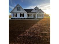 White house with black shutters, a large yard, and a spacious driveway at 3538 Good Luck Rd., Aynor, SC 29511