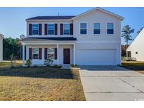 Two-story house with a beige exterior, brown shutters, and a two-car garage at 443 Archer Ct., Conway, SC 29526