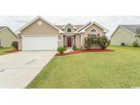 House exterior featuring a two-car garage and well-maintained lawn at 333 Carolina Springs Ct., Conway, SC 29527