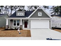 Gray two-story house with white garage door and red front door at 1205 Nw Calabash Station Blvd., Calabash, NC 28467