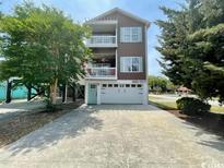 Two-story home with double garage and landscaped yard at 121 B 7Th Ave. S, Surfside Beach, SC 29575