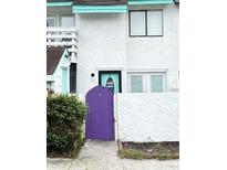 Exterior view of a townhome with purple gate and teal door at 306 21St Ave. S # 4A, Myrtle Beach, SC 29577
