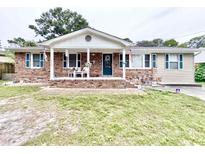 Charming ranch-style home with brick facade and covered porch at 703 62Nd Ave. N, Myrtle Beach, SC 29572