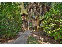 Brick house with a walkway, lush landscaping, and a gated entry at 19 South Gate Rd., Myrtle Beach, SC 29572