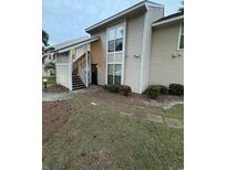 Exterior view of a two-story condo building with stairs at 4497 Little River Inn Ln. # 1504, Little River, SC 29566