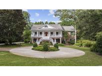 Two-story brick home with circular driveway and landscaped yard at 4400 Saint Andrews Ct., Murrells Inlet, SC 29576