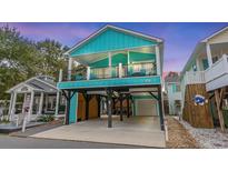Charming beach cottage with elevated design, spacious deck, and attached garage at 6001 - V-5 S Kings Hwy., Myrtle Beach, SC 29575