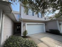 Two story light beige townhome with a two-car garage at 1188 Fairway Ln. # 7, Conway, SC 29526