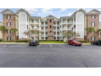 Brick building exterior with parking and landscaping at 4812 Magnolia Lake Dr. # 102, Myrtle Beach, SC 29577