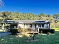 Brick ranch house with a carport, ramp, and well-maintained lawn at 3285 Della Rd., Longs, SC 29568