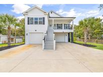 Two-story home with white siding, gray trim, and a two-car garage at 5848 Creekside Dr., Myrtle Beach, SC 29588