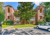 Front view of a brick apartment building with parking at 4273 Villas Dr. # 1007, Little River, SC 29566