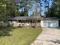 Brick ranch house with a two-car garage and a well-maintained lawn at 110 Brookgate Dr., Myrtle Beach, SC 29579