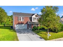 Brick house with a two-car garage and a well-maintained lawn at 2248 Beauclair Ct., Myrtle Beach, SC 29579