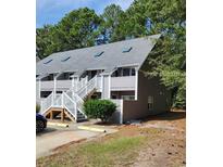 Two-story building with gray siding and white railings at 421 Cambridge Circle # F8, Murrells Inlet, SC 29576