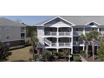 Two-story townhouse with gray siding and balconies at 5801 Oyster Catcher Dr. # 1531, North Myrtle Beach, SC 29582
