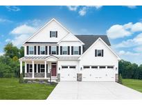 Two-story farmhouse style home with three car garage and manicured lawn at 743 Indigo Bay Circle, Myrtle Beach, SC 29579