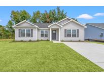 Newly built home with gray siding, landscaping, and a paved driveway at 326 Barn Owl Way, Conway, SC 29527