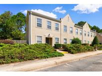 Tan three-story townhome with multiple windows and landscaping at 4541 Girvan Dr. # 27-D, Myrtle Beach, SC 29579
