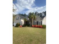 Two-story house with a two car garage, landscaping and palm trees at 621 Elgin Ct., Myrtle Beach, SC 29579