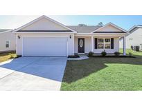 Newly built home with a two-car garage and manicured lawn at 322 Barn Owl Way, Conway, SC 29527