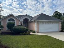 Charming one-story home with a two-car garage and manicured lawn at 3959 E Glades Dr., Myrtle Beach, SC 29588