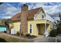 Yellow house with a second story deck at 704 43Rd Ave. S, North Myrtle Beach, SC 29582
