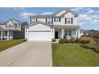 Two story house with attached garage and landscaped front yard at 5700 Redgum Dr., Myrtle Beach, SC 29579