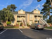 Attractive two-story condo with stairs, palm trees, and parking at 3831 Masters Ct. # 137, Myrtle Beach, SC 29577