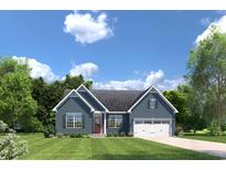 Ranch style home with gray siding, two-car garage, and landscaped lawn at 763 Indigo Bay Circle, Myrtle Beach, SC 29579