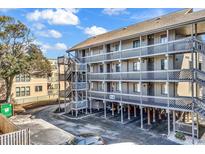 Three-story building exterior with balconies and parking underneath at 9621 Shore Dr. # G219, Myrtle Beach, SC 29572