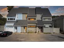 Two-story townhome with light blue and gray siding at 7300 Porcher Dr. # 8, Myrtle Beach, SC 29572