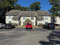 Exterior view of a condo building with parking lot at 4498 Little River Inn Ln. # 2403, Little River, SC 29566