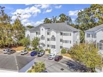 Aerial view of a three-story building with parking at 1525 Lantern Rest Dr. # 301, Myrtle Beach, SC 29579