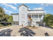 Two-story waterfront home with gray siding and orange door at 204 5Th Ave. N, North Myrtle Beach, SC 29582