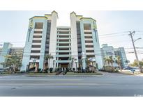 Oceanfront building exterior with parking and landscaping at 6804 N North Ocean Blvd. # 933, Myrtle Beach, SC 29572