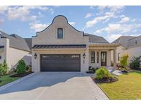 Brick home with dark brown garage door and landscaping at 8407 Cape Dutch Loop, Myrtle Beach, SC 29572