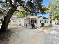 Charming white cottage with porch and fenced yard at 6001 - M26 S Kings Hwy., Myrtle Beach, SC 29575